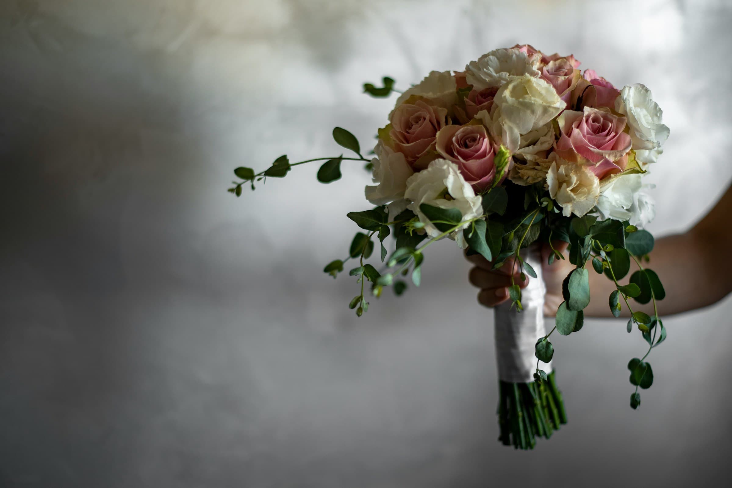 Bridal bouquet held up by bride