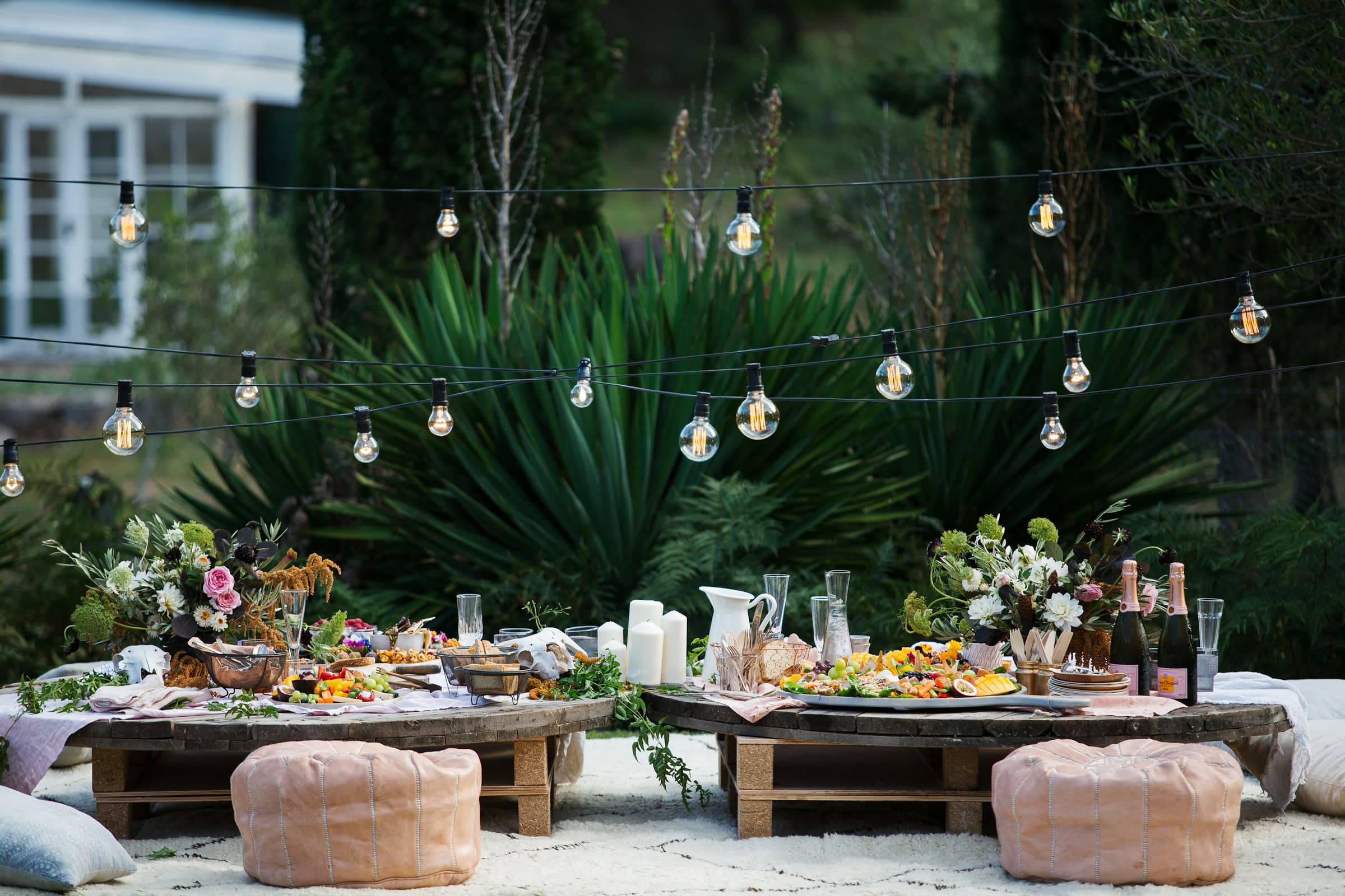 Rustic wedding charcuterie with flowers and drinks set up on table