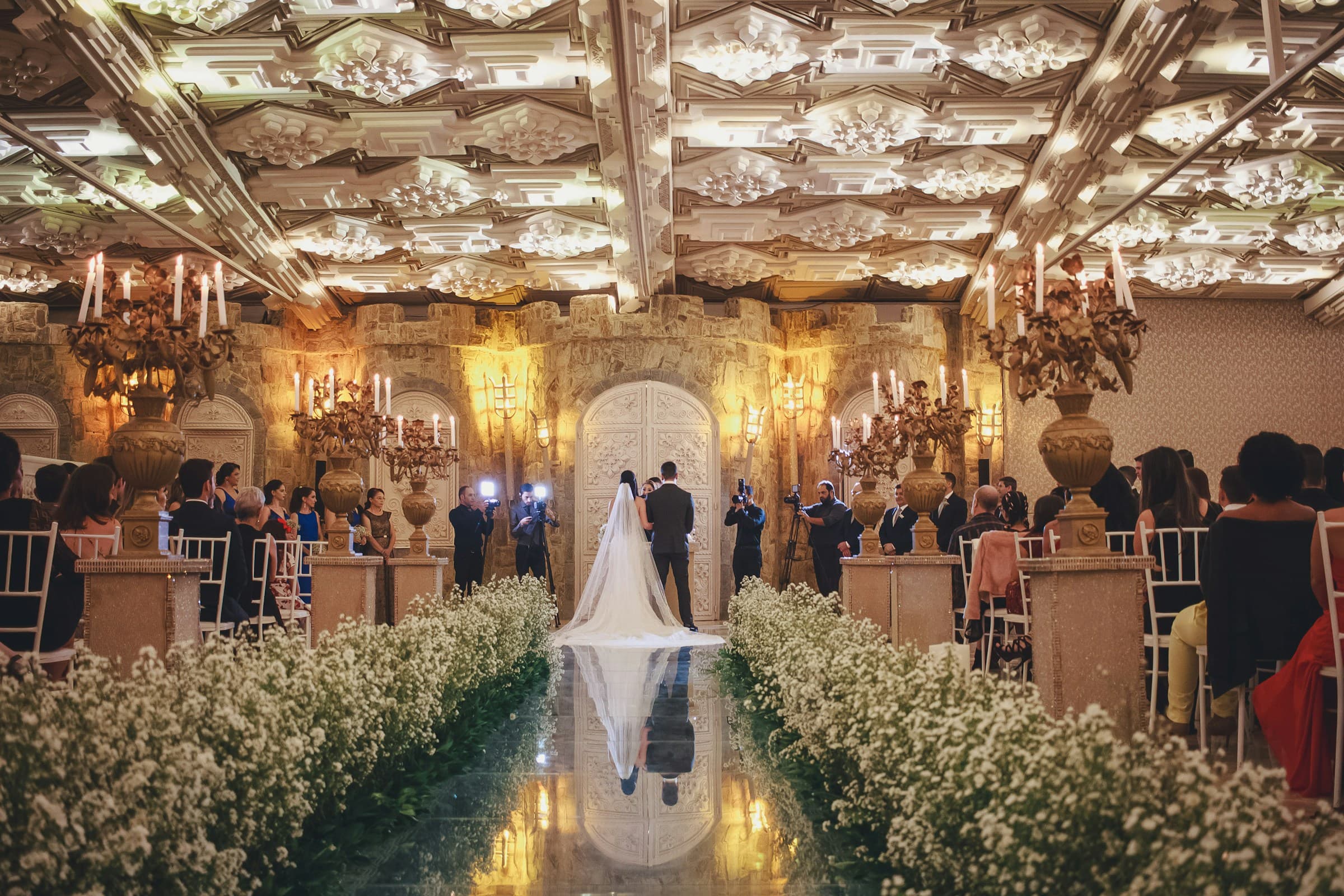 Bride and groom at end of the aisle during wedding ceremony at indoor wedding venue