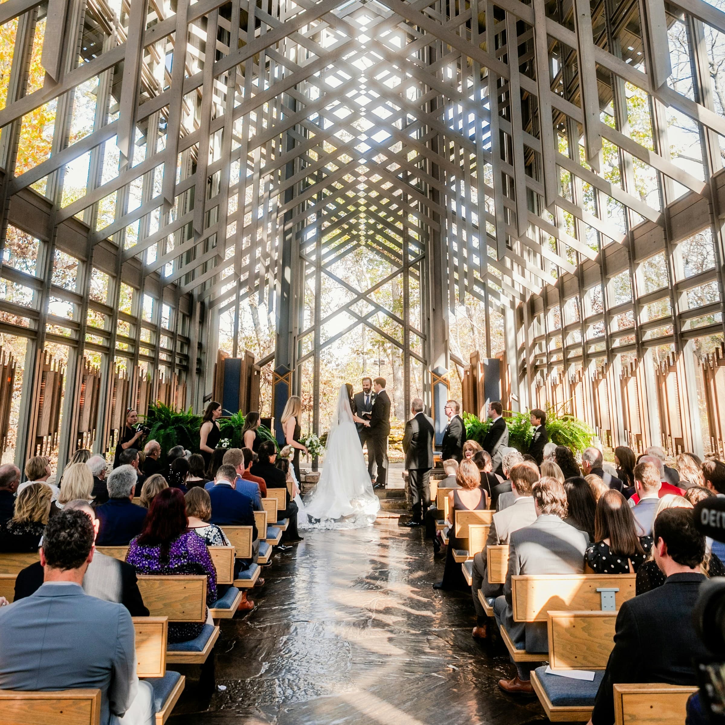 Wedding ceremony indoors with guests observing in modern design venue