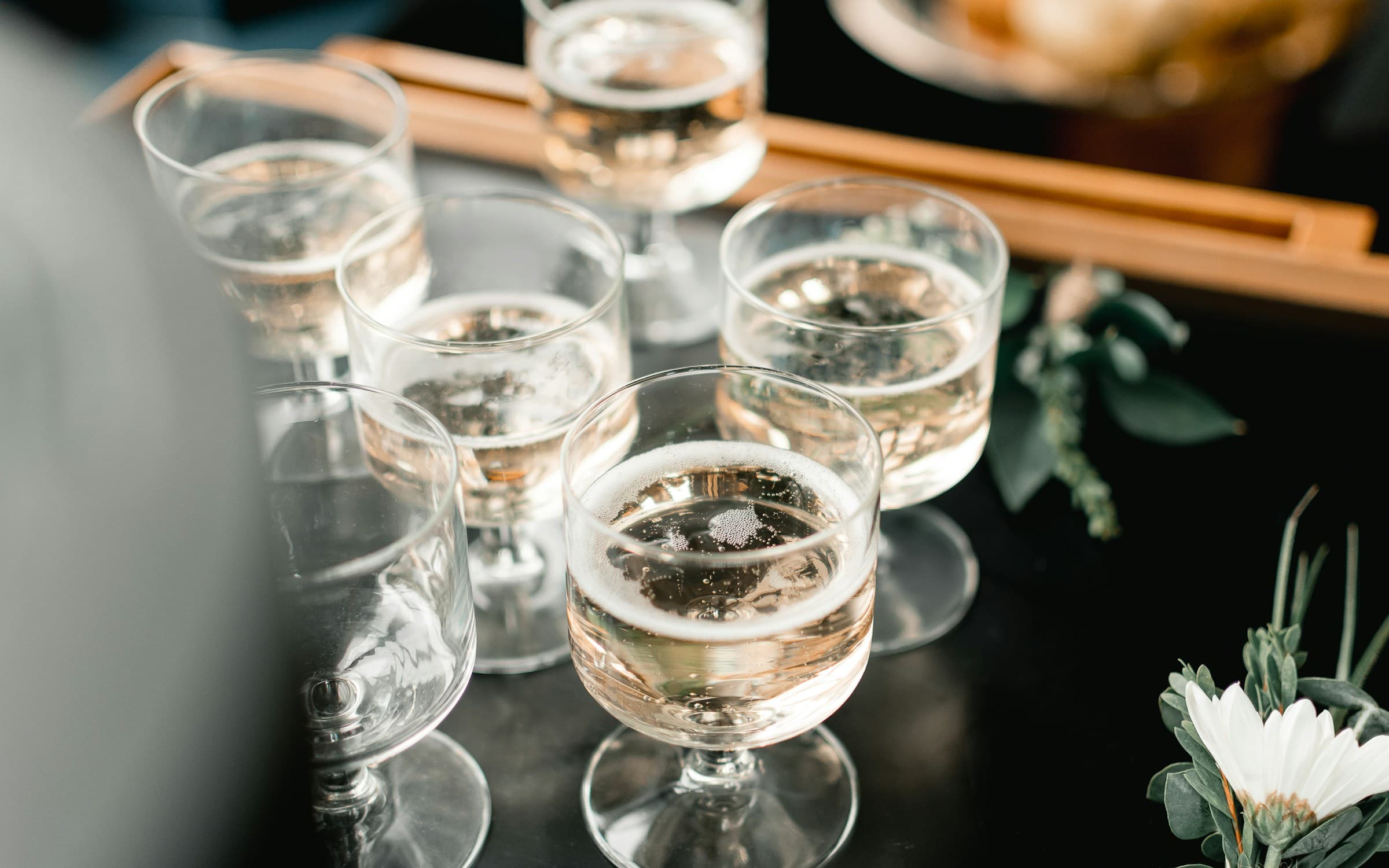 Bubbly cocktails atop wedding reception bar for bridal party