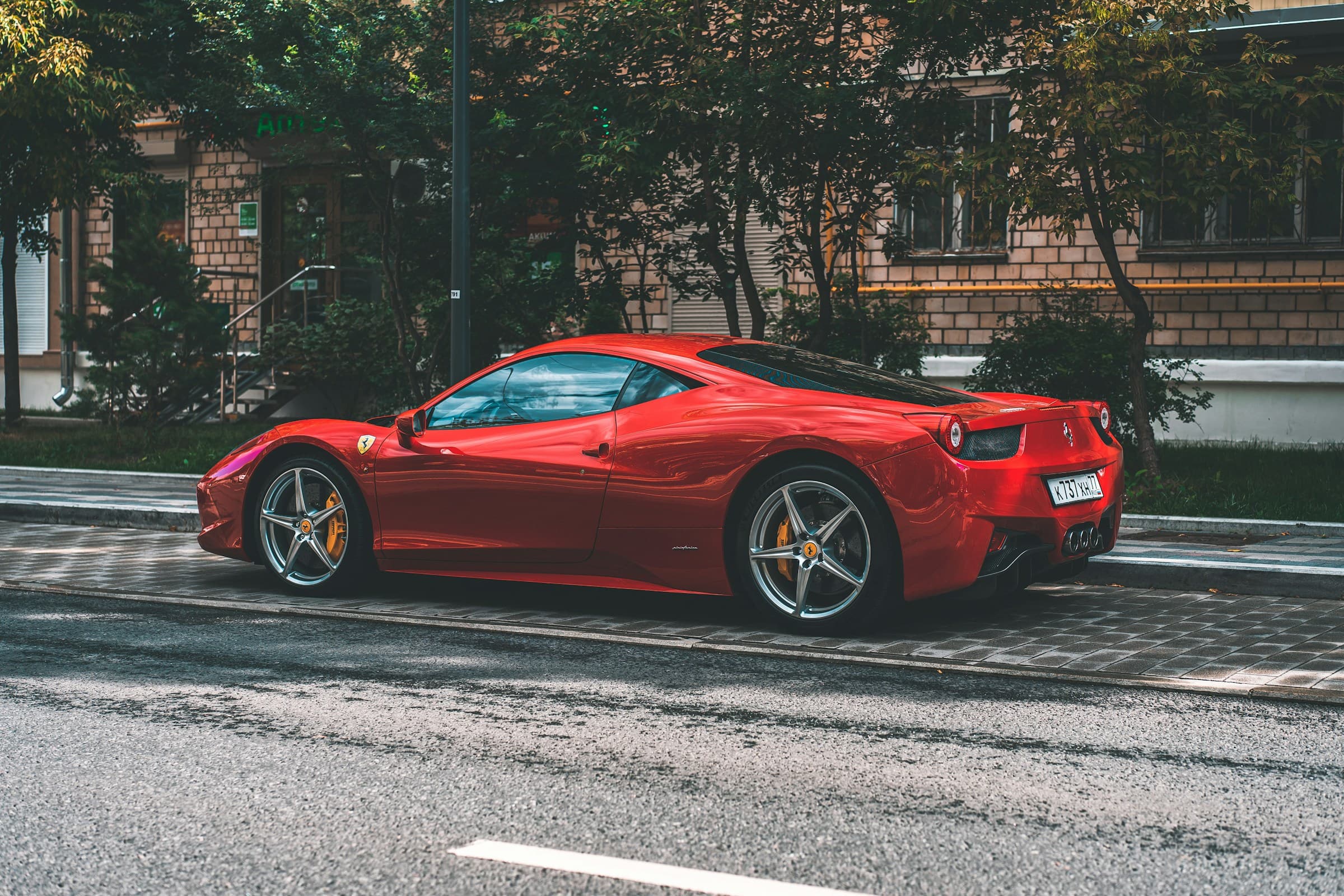 Red Ferrari parked on side of street awaiting bride and groom to depart wedding ceremony